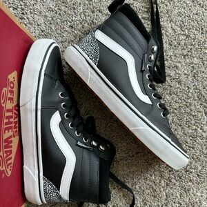 Women’s size 7 Vans Hi-Top, black leather and leopard print details.